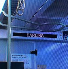 there is a sign that says daring on the back of a bus seat with wires hanging from it