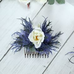 "Scottish Thistle Blue Artificial Hair Comb! Please check pictures before purchasing. This hair piece is made up of plastic materials and some silk materials.  A handmade simple design. Decorative artificial blue Thistle Rose hair comb.  Set on a silver hair comb sits two thistles and two Ivory Roses.  Perfect for a Scottish Country style wedding or occasion.  Sizes approx: 5.5\" Includes: Thistle, Roses Colours: Blue and ivory.  We have a matching bouquet, buttonholes and corsages. Please click on link below.If you need flowers sooner than the timescale specified please contact us as we may still be able to help." Thistle Blue, White Bridal Flowers, Bridal Flower Hair Comb, Floral Hair Crown, Rose Gold Hair Accessories, Ivory Wedding Flowers, Floral Hair Accessories, Bridal Head Piece, Gold Hair Piece