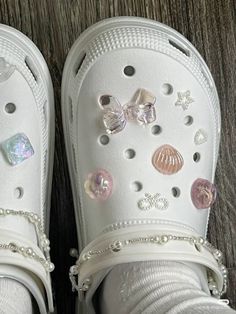 a pair of white shoes with buttons on them