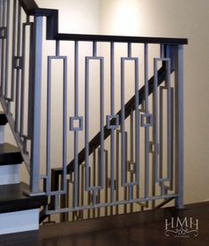 a stair railing in an empty room with wood flooring