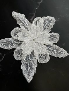 an image of a snowflake on a black surface