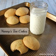 cookies on a tray next to a jar of teacakes with the words nanny's tea cakes