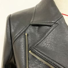 Add edgy vibes to your wardrobe this season with our Edgy Vegan Leather Biker Jacket. The jacket is embellished with gold buttons. zipper details. side pockets. and a removable belt at the waist. We love pairing this Edgy Vegan Leather Biker Jacket with a pair of skinny jeans and boots for a day-to-night cool girl look! Refer to the size chart to select your size. Edgy Vibes, Faux Leather Motorcycle Jacket, Button Embellishments, Gold Lion, Ribbed Mini Dress, Leather Motorcycle Jacket, Leather Biker Jacket, Silver Dress, Zipper Detail