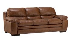 a brown leather couch sitting on top of a white floor