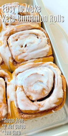 cinnamon rolls with icing sitting in a baking pan