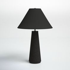 a black table lamp with a black shade on the base and a white wall behind it