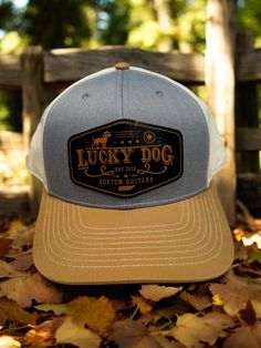 Structured, non mesh Gray/khaki/cream Lucky Dog Custom Guitars trucker hat.  Large embroidered patch & snap-back adjustment.  Cream cotton back. *This hat is "Regular size" which is the standard size cap sold in most stores to fit the majority of people (Med/Large fit).    ((We do offer  oversized XXL ballcaps as well (in other listings) that fits people with larger than average noggins. Dog Custom, Lucky Dog, Custom Guitars, Snap Back, Grey Khakis, Snap Backs, Embroidered Patch, Ball Cap, Embroidered Patches