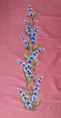 a pink background with blue flowers and green leaves on the bottom right hand corner is an embroidered design