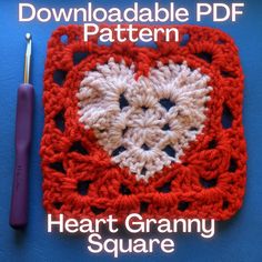 a crocheted square with a heart in the center and a crochet hook next to it