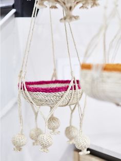 a white and pink hammock hanging from the ceiling