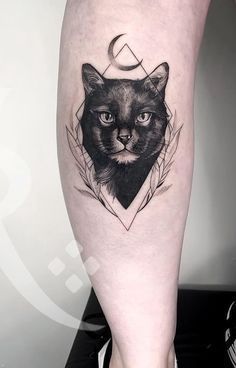 a black cat tattoo on the right leg with an arrow and crescent moon above it