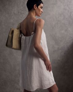 Hello, chic-at-the-beach style. Lightweight & effortless, our 100% European Linen Spaghetti Strap Mini Dress works great as a beach coverup or everyday dress. Pictured here with our 100% Organic Canvas Large Tote. Summer Linen Sundress With Straight Neckline, Summer Linen Dress With Square Neck, Linen Square Neck Dress With Tie Straps, Casual Linen Dress With Adjustable Straps For Brunch, Casual Linen Square Neck Dress For Summer, Casual Linen Dress With Square Neck For Summer, Linen Dress With Tie Back And Square Neck, Casual Linen Dress With Square Neck For Brunch, Casual Square Neck Linen Dress For Brunch