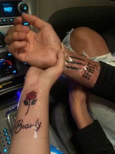 two people with matching tattoos on their arms