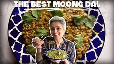 a woman holding a plate with food on it and the words, the best moong dal