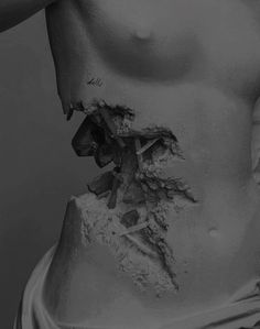 black and white photograph of a woman's stomach with dirt all over her body