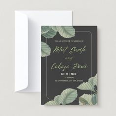 a wedding card with leaves on it