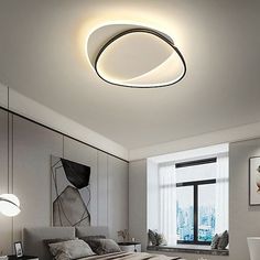 a bed room with a neatly made bed and a round light above the headboard