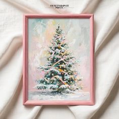 a painting of a snowy pine tree in pink frame on a white sheeted bed