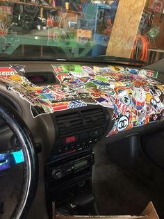 the interior of a car with stickers all over it's dash board and dashboard