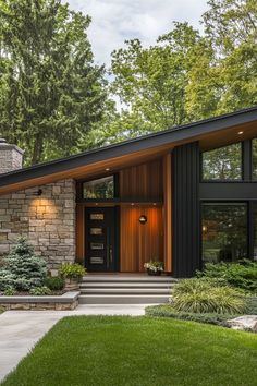 a modern house with stone and wood accents in the front yard, surrounded by lush green trees