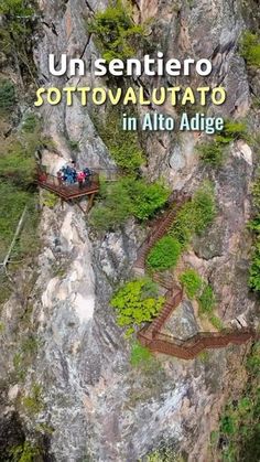 an aerial view of people walking on wooden walkways in the middle of a mountain