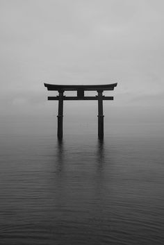 a large body of water with a wooden structure in the middle