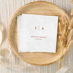 two napkins sitting on top of a wooden plate