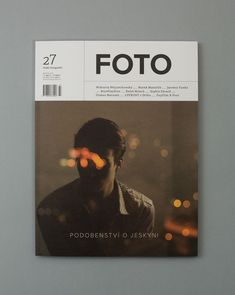 a magazine with a man's face on the cover and blurry lights in the background