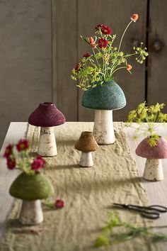 three different colored mushrooms sitting on top of a table