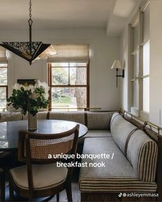 a living room filled with furniture and a dining table in front of a large window