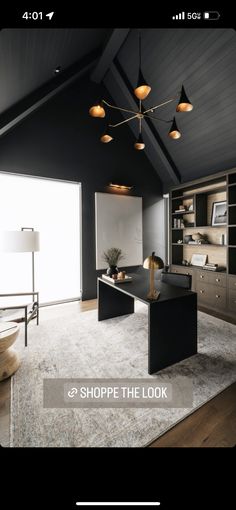 a black and white office with lots of lights on top of the desk, along with an area rug in front of it