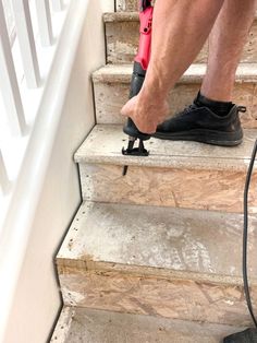 a man in black shoes is on the stairs with an electric cord attached to his shoe