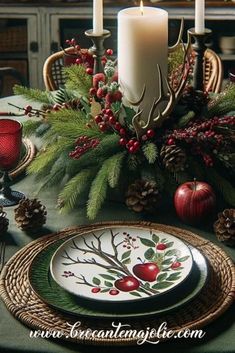 a christmas table setting with candles and plates