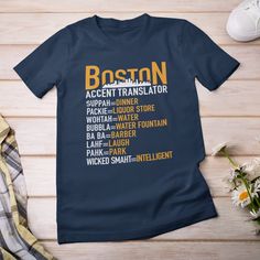 "IMPORTANT: 🚨 Unisex T-Shirts run fitted. Please order a size up for a looser fit👕 Dive deep 🌊 into the heart ❤️ of Beantown with our Boston Accent Translator tee! Celebrate 🎉 the iconic phrases that make Boston unique, all while educating 📚 those unfamiliar with the local vernacular. Each phrase, from the classic \"SUPPAH\" for \"DINNER\" 🍽️ to the endearing \"WICKED SMAHT\" for \"INTELLIGENT\" 🧠, is printed in bold, making it a standout piece in any wardrobe. Not only does this shirt pay homage to the rich linguistic tapestry 🎭 of Boston, but it also serves as a nod 🙌 to the city's vibrant culture and history 🏛️. Whether you're a Boston native wanting to wear a piece of home 🏠 or a visitor looking for the perfect souvenir 🎁, this t-shirt encapsulates the city's spirit. Crafte Fitted Short Sleeve Tops With Team Name, Fitted Sports T-shirt, Fitted Pre-shrunk T-shirt For Sports, Casual Fitted T-shirt With Team Name, Funny Sweatshirts Hoodie, Boston Accent, Boss' Day, Work Anniversary, Movie Shirts