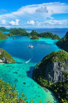 an aerial view of the blue lagoons and boats in the water, surrounded by tropical vegetation