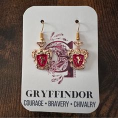 pair of red and gold earrings on card with logo for gryffindor courage