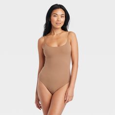 This 4-Way Stretch Cami Bodysuit from Auden™ in a solid color features a sleeveless silhouette with a breezy scoop neckline, cotton gusset for breathability and snap buttons on the crotch. Made from lightweight four-way stretch fabric with adjustable shoulder straps, it offers a comfortable, customized fit that moves with you, and the opaque lining offers confident wear. You can wear this pullover bodysuit with everything from wide-leg trousers to joggers to shorts, and add layering pieces for v Summer Scoop Neck Shapewear Camisole, Summer Shapewear Camisole With Scoop Neck, Summer Scoop Neck Shapewear Bodysuit, Summer Shapewear Bodysuit With Scoop Neck, Summer Tank-style Shapewear Camisole, Fitted Scoop Neck Camisole For Beach, One Piece Clothing, Cami Bodysuit, One Piece Bodysuit