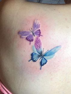 two butterflies on the back of a woman's stomach