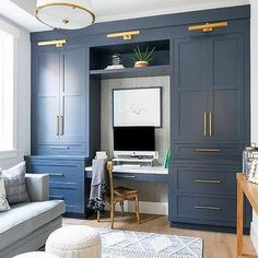 a living room filled with furniture and a flat screen tv on top of a desk