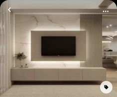 a modern living room with white walls and beige carpeted stairs leading up to the tv