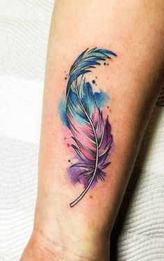 a watercolor feather tattoo on the ankle