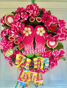 a welcome wreath with pink flowers and flip flops