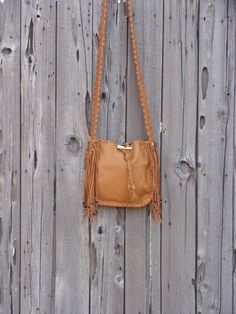 This leather tote is a great size for your every day needs. This bag is made of saddle tan leather and is 10 inches tall, 10 inches wide and 2.75 inches deep. We can make this bag in any of the colors of leather you see in our shop. It has an extra pocket inside and a comfortable 48 inch flat strap. Let us know how long you like your strap. We can make this bag in a variety of colors of soft tanned cowhide ( see the last photo ). Just leave a note at check out or contact us... This item is MADE Camel Satchel Shoulder Bag For Fall, Daily Use Crossbody Bucket Bag With Tassels, Daily Crossbody Bucket Bag With Tassels, Camel Bag With Adjustable Strap For Fall, Fall Camel Bags With Adjustable Strap, Fall Camel Bag With Adjustable Strap, Fall Fringe Shoulder Bag For Daily Use, Fringe Shoulder Bag For Fall, Fall Fringe Shoulder Bag