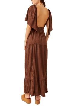 Easy and enchanting, this breezy plunge-neck maxi features fluttering sleeves and a flouncy tiered skirt. 57" length (size Medium) Plunge neck Elbow-length sleeves 65% polyester, 34% viscose, 1% elastane Machine wash, tumble dry Imported Brown Ruffled Maxi Dress For Spring, Chic Tiered Dress With Flutter Sleeves For The Beach, Bohemian Brown Tiered Maxi Dress, Flowy V-neck Tiered Dress For Beach, Flowy V-neck Tiered Beach Dress, Brown Ruffle Hem Dress For Beach, Bohemian Maxi Dress With Ruffle Sleeves, Solid Tiered Maxi Dress With Ruffle Hem, Brown Ruffled Maxi Dress For Vacation