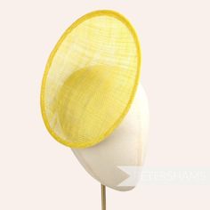 This rounded scoop fascinator hat base is made from a double layer of yellow stiffened sinamay millinery fabric and is ideal for making an instant fascinator! The scooped center of the disc allows you to get creative by positioning it at different angles on the head.  Just add elastic, headband or comb for securing to the head (not included but available in our shop!) Measurements: Diameter: 21cm (8.2 inches) Height: 2cm (0.7 inches)  Available in several colours from our millinery supply store Sinamay Fabric, Sinamay Fascinator, Blank Hats, Sinamay Hats, Millinery Supplies, Round Hat, Hat Base, Large Hats, Yellow Hat