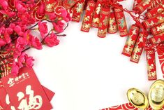 red and gold decorations with chinese writing on them, along with two pairs of scissors