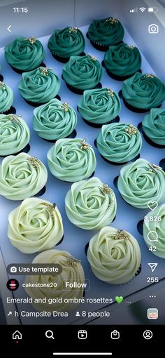 cupcakes with green frosting sitting in a box