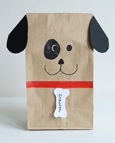 a brown paper bag with a dog's face on it and a bone in the middle