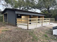 a horse barn with two stalls and one stall attached to the side of the building