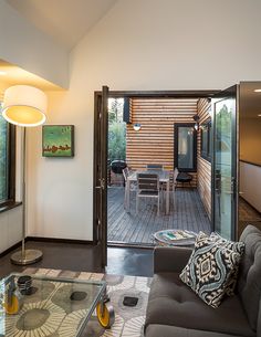 a living room filled with furniture and a sliding glass door that leads to a deck